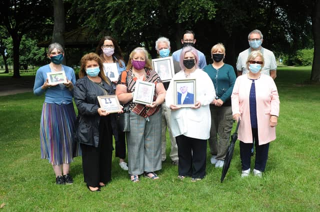 Relatives of those who died in Dealgan House hold photos of loved ones who passed away last year