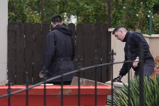 Gardai continue a search of waste ground behind a house in Dundalk. Credit: Brian Lawless/PA Wire