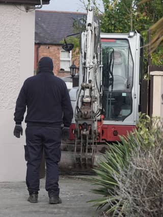 A mechanical digger used by Gardai leaves the area. Brian Lawless/PA Wire
