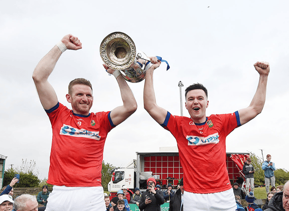 Ardee St Mary's captain's Liam Jackson (right) and Robbie Leavy lift the Joe Ward Cup. Picture by Arthur Kinahan.