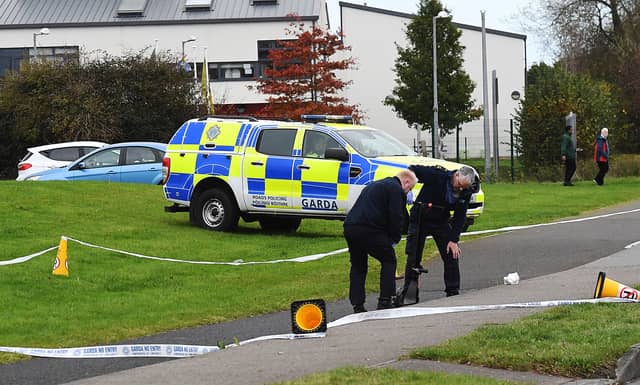 Gardai examining the scene of the incident on Tom Bellew Avenue where a young woman who was travelling on an e-scooter was discovered seriously injured. Photo: Arthur Kinahan