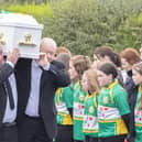 The remains of young Ronan Wilson is carried in St Mary's Church at Dunnamore by family members as it passes a guard of honour by members of the local GAA club.  (NW Newspix)