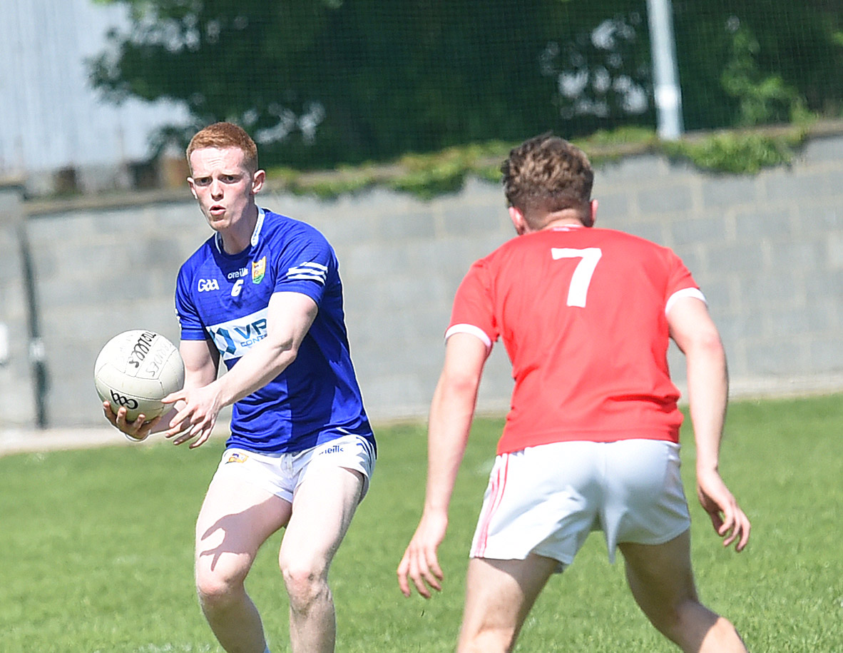 Ardee's Paraic McKenny is confronted by St Bride's Evan Wynne during their recent Div 1 game in Pairc an Chuinnigh. (Picture: Arthur Kinahan)