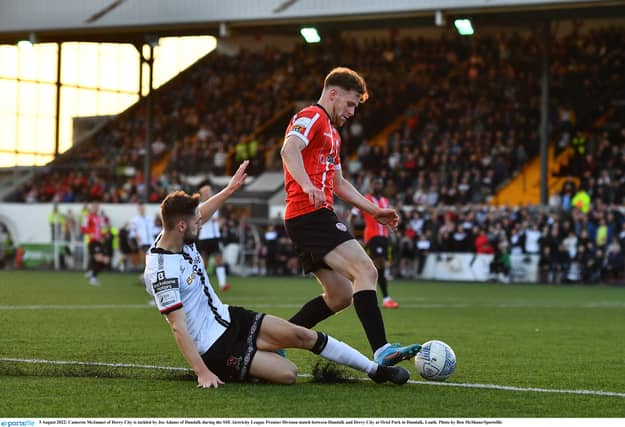 Cameron McJannet of Derry City is tackled by Joe Adams. This was one of many great battles fought across the field during a thrilling contest at Oriel Park. (Photo: Sportsfile)