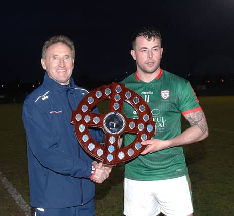 Peter Fitzpatrick, Chairman of the Louth County Board presenting the Kevin Mullen Shield to James Butler, Captain of the Glen Emmets team. (Pic: Arthur Kinahan)