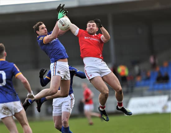Sam Mulroy battles for possession against Longford midfielder Darren Gallagher. (Photo: Syl Healy)