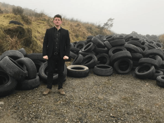 Sinn Féin Councillor Antóin Watters with a previous tyre dump in Cooley