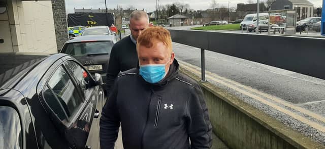 Declan Haughney (front, wearing mask) arrives at Kilkenny Courthouse this morning