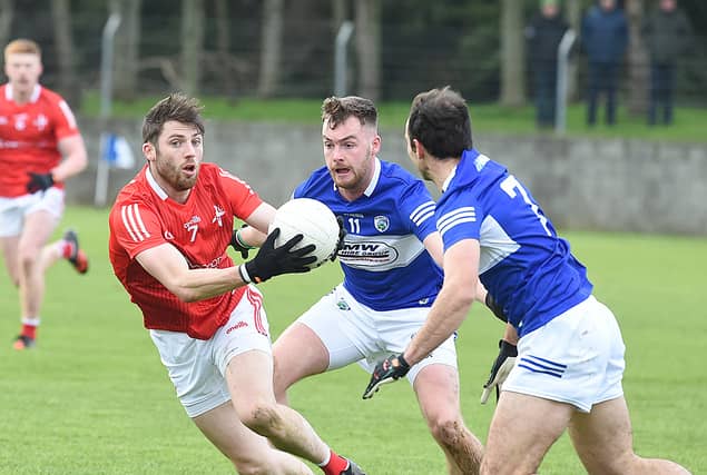 John Clutterbuck under preasure from Laois players Eoin Lowry and Gareth Dillon. (Pic: Arthur Kinahan)