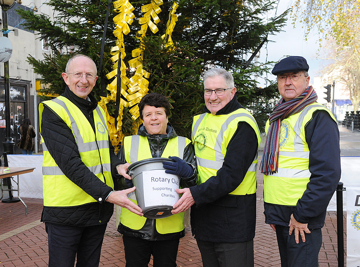Rotary members Con Shanahan, Catherine White , Tom Clarke and Tony Nordon  collecting at the  Remembrance  Tree in Earl Street (PIC: Arthur Kinahan)