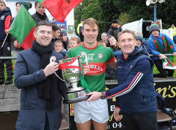 Glen Emmets captain Conor Grimes is presented with the Christy Bellew Cup following his side's victory over John Mitchels. (Pic: Arthur Kinahan)