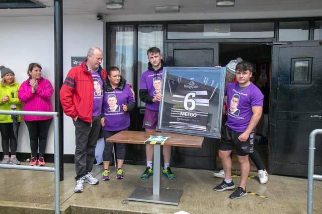 Caolan Meegan's Dundalk RFC Teammates David Murdock and Zak Coan present his number Six Jersey to his parents Patrick and Julie