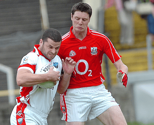 Louth's Colin Goss rattled into Cork's Michael Cussen during the 2007 All-Ireland qualifier at O'Moore Park, Portlaoise. (Pic: Arthur Kinahan)