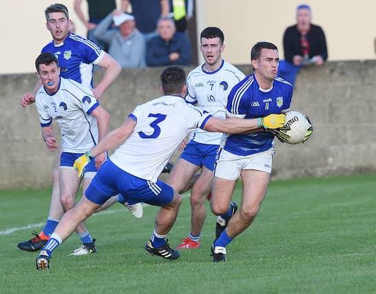 Roche Emmets' Liam Carthy evades Paul McGeough of Lannléire during the drawn semi-final in Stabannon. (Pic: Arthur Kinahan)