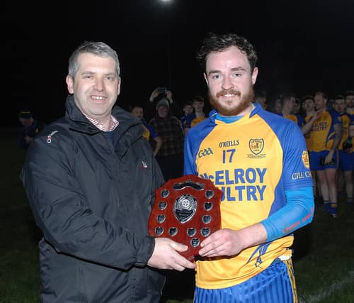 Louth County Board chairman Des Halpenny presents the Paddy Sheelan Shield to Rian Hand, Kilkerley Emmets' captain, on Friday night. (Pic: Arthur Kinahan)