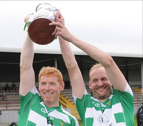 O'Raghallaighs' Andrew Rogan and Ciarán Brassil lift the Division Two title after today's victory over Kilkerley Emmets. (Pic: Arthur Kinahan)