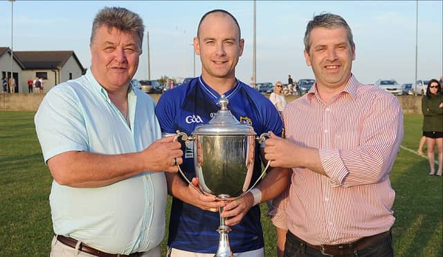Seamus Sheelan presenting the Paddy Sheelan Cup to St. Mary’s captain Darren Clarke with Louth County Board chairman Des Halpenny. (Pic: Arthur Kinahan)