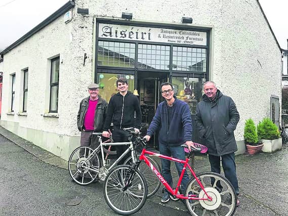 Simon Chan the founder of the Super Wheel (second from right), along with Oisín (second from left) and two Carlingford locals during a recent test cycle through the Louth village.