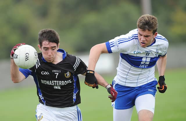Eoghan Callaghan (Naomh Máirtín) is shackled by Seán Murray of Dundalk Gaels. (Pic: Arthur Kinahan)