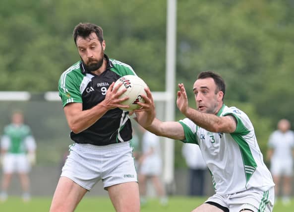 Robert Mulroy (left) was a key man in the O'Raghallaigh's maintaining their senior status tonight. (Pic: Ciarán Culligan)