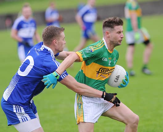 Stephen Fisher (Sean O'Mahony's) is tackled by David Moloney of Dundalk Gaels. (Pic: Arthur Kinahan)