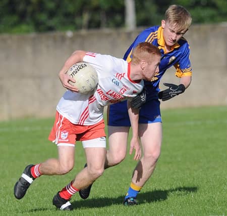 Adam Gartland (Tones) keeps a close eye on Mitchels' forward Mikey Nulty. (Pic: Arthur Kinahan)