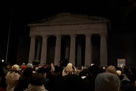 Attendees at the Yosuke Sasaki vigil listen to Lyndsey O'Neill singing John Lennon's 'Imagine'
