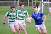 Liam Jackson of St. Mary's taking on Jamie McDonnell and James McGlew of St. Fechins