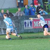 Eoin McCooey of Newtown Blues gets past St Mary's goalkeeper Tiernan Markey