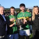 Conor Osborne and Josh Crosbie (Naomh Fionnbarra joint captains) receiving the Christy Bellew Cup from Sean McClean (Chairman LCB) CHairman and Kelly Connor (sponsor DKIT Sport)