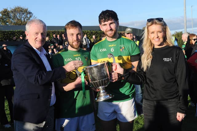 Conor Osborne and Josh Crosbie (Naomh Fionnbarra joint captains) receiving the Christy Bellew Cup from Sean McClean (Chairman LCB) CHairman and Kelly Connor (sponsor DKIT Sport)