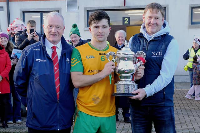 Sean McClean (LCB Chairman) and Billy Lawlor (sponsors CTI Business Soltutions) presenting the Seamus Flood Cup to Bobby Butterly (Stabannon Parnells captain)