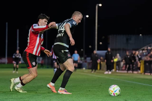 Tom Grivosti of Dundalk against James Clarke of Derry City