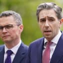 Patrick O'Donovan standing next to Simon Harris, who is speaking