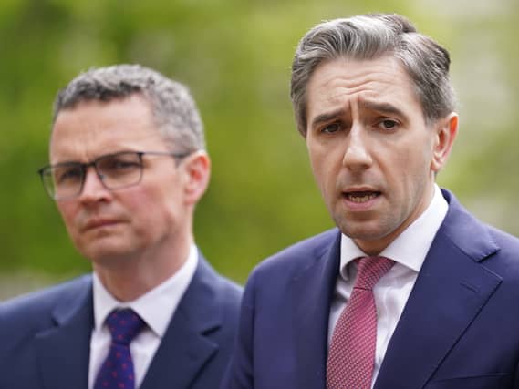 Patrick O'Donovan standing next to Simon Harris, who is speaking
