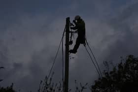 A network technician on a power pole