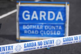 Garda crime scene tape and road closed sign