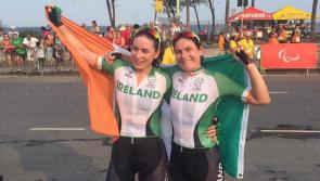 President Higgins congratulates McCrystal and  Dunlevy's medal success