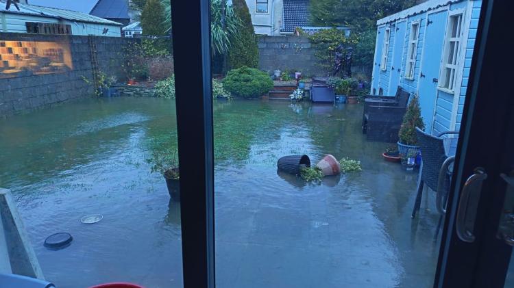 PHOTOS: Cllr Nash helps unblock gullies as Bay Estate in Dundalk remains flooded