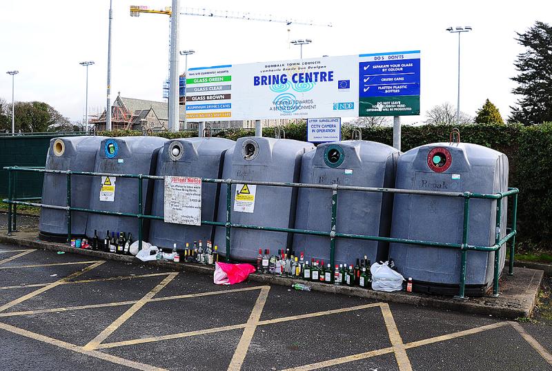 Glass bottles littered around overflowing Dundalk bottle bank
