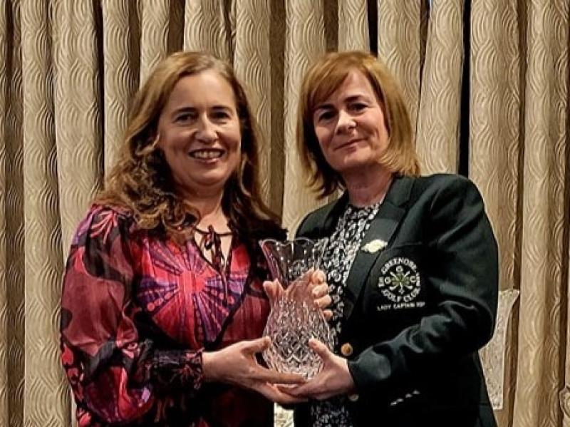 Roisin Finn receives her Green Trophy from Greenore Lady captain Lisa Cruden