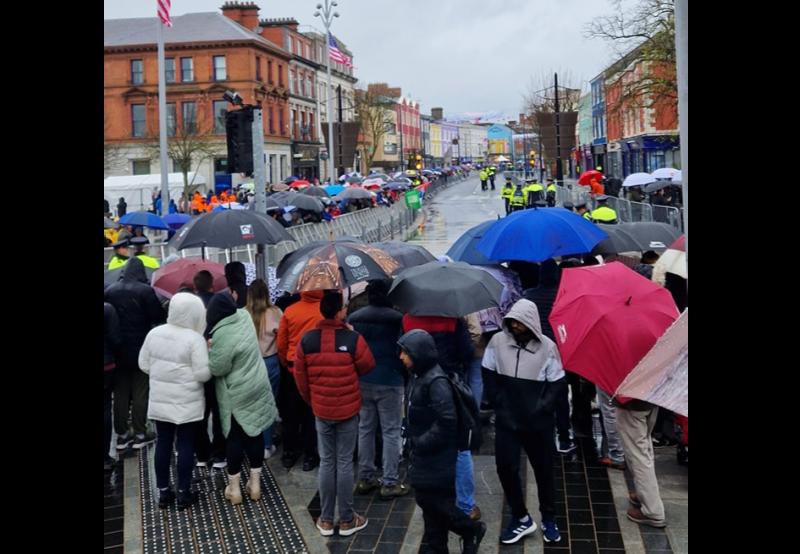 People braving the rain waiting to welcome President Joe Biden to Dundalk