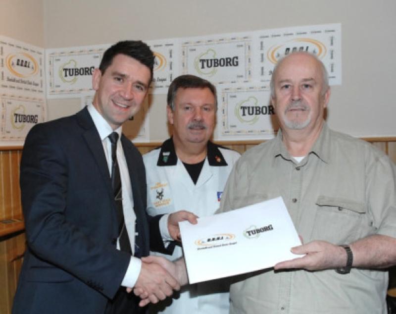 James Clooney of Tuborg handing over the sponsorship cheque for the  Dundalk and District Darts League to Peter Neary (Treasurer) and Brendan O'Rourke (Chairman) at the launch night in the Avenue Inn last Thursday