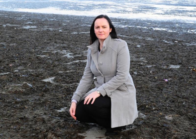 Cllr Maria Doyle on a bed of Seaweed on Blackrock beach